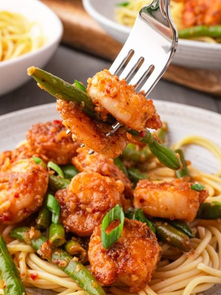 Chili Crisp Shrimp on a plate with a fork