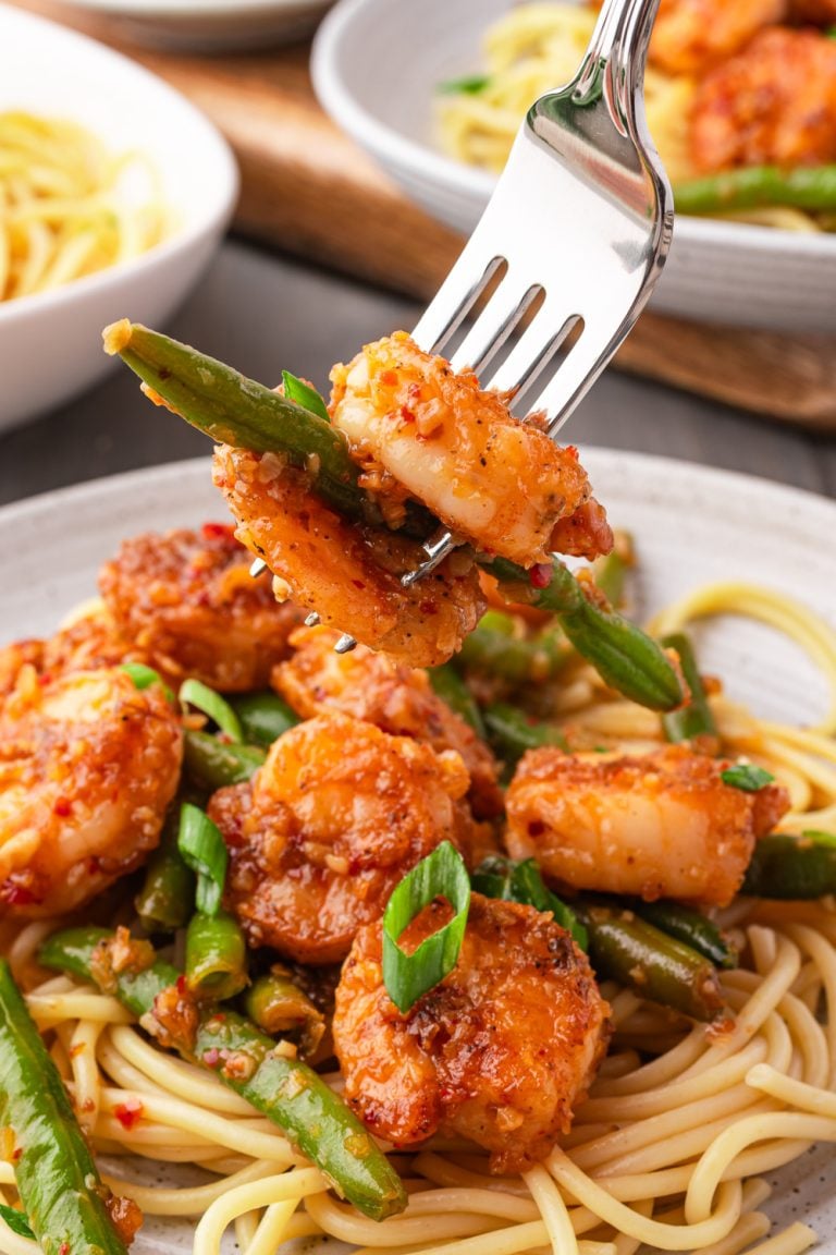 Chili Crisp Shrimp on a plate with a fork
