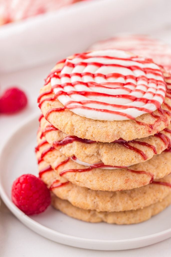Copycat Crushed Raspberry Cheesecake Cookies Stacked on Plate
