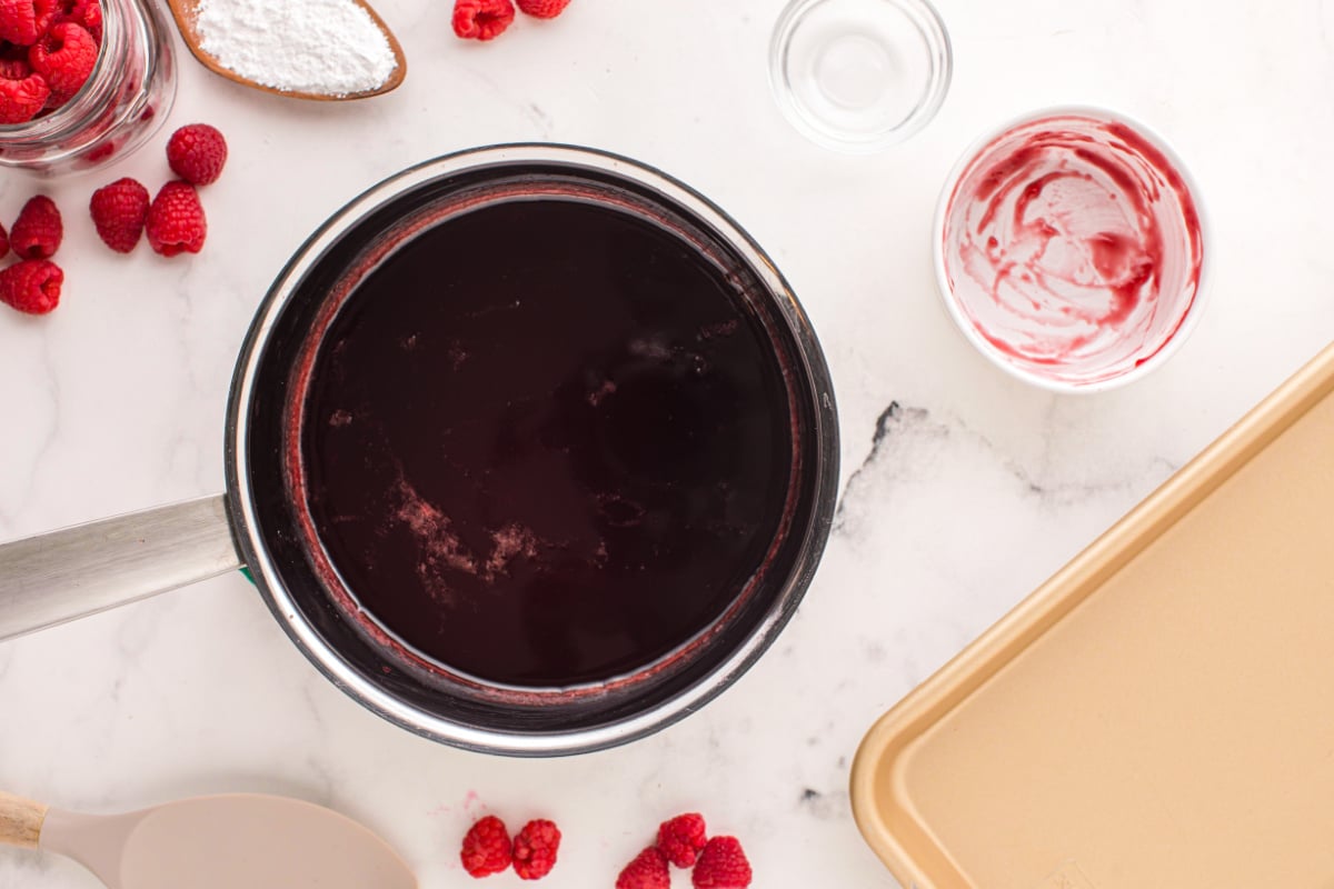 Pour raspberry jam into pan