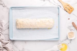 butter and sesame seeds added to top of roll
