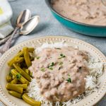 Easy Beef Hamburger Gravy on a plate with rice and beans