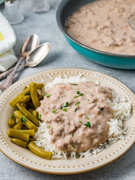 Easy Beef Hamburger Gravy on a plate with rice and beans
