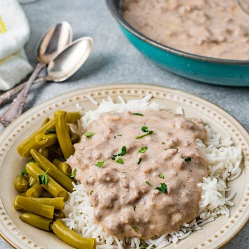 Easy Beef Hamburger Gravy on a plate with rice and beans