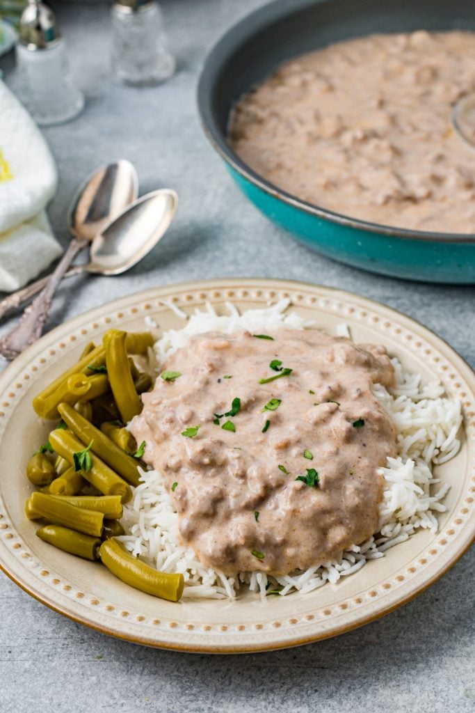 Easy Beef Hamburger Gravy on a plate with rice and beans