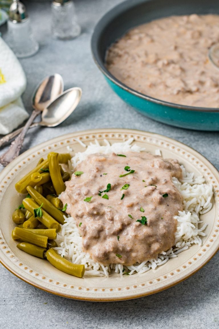 Easy Beef Hamburger Gravy on a plate with rice and beans