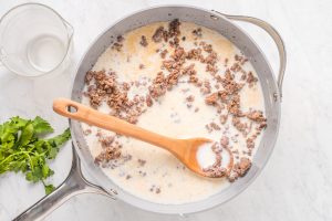 stirring beef mixture in a pan
