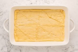crescent rolls placed in bottom of baking pan