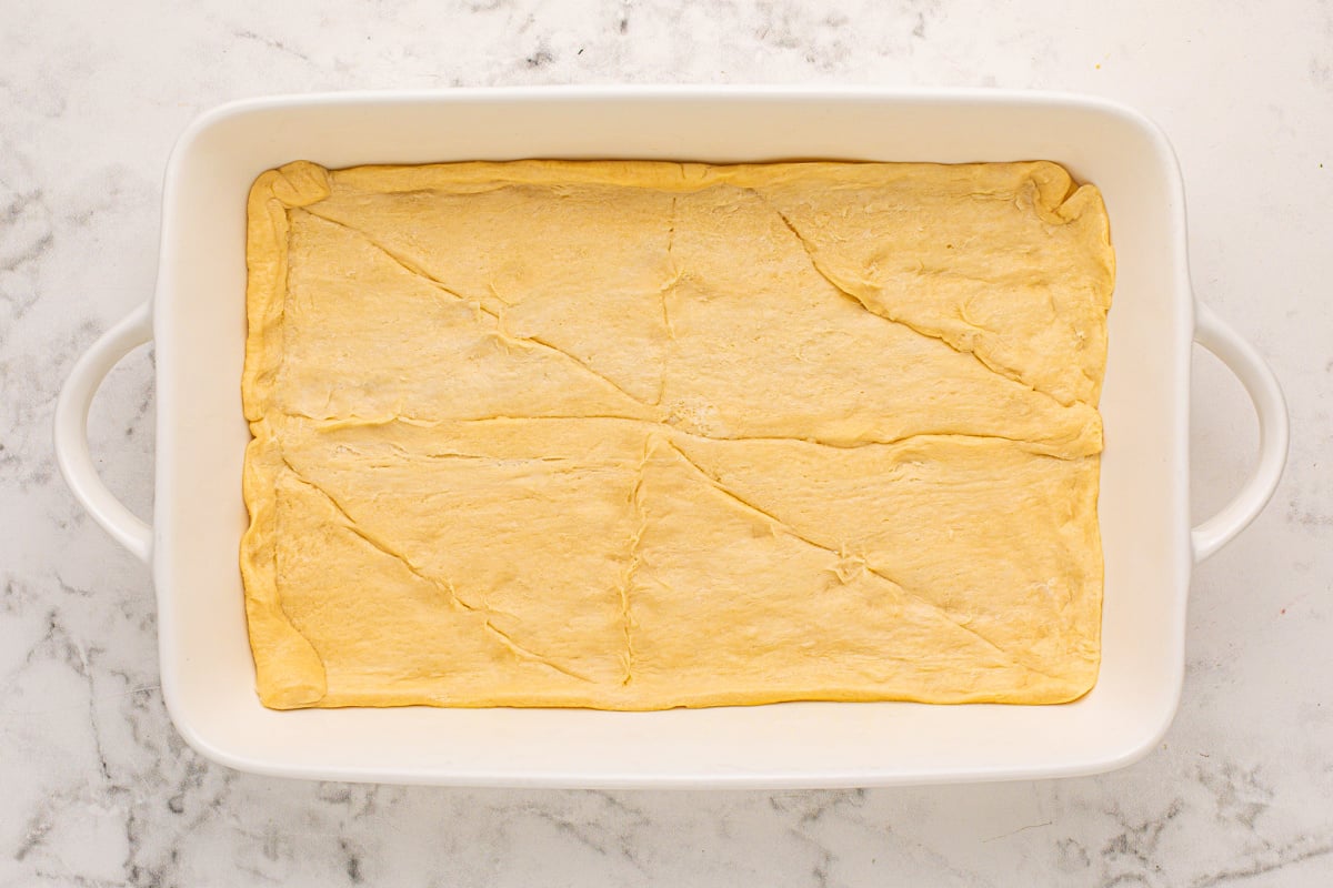 crescent rolls placed in bottom of baking pan