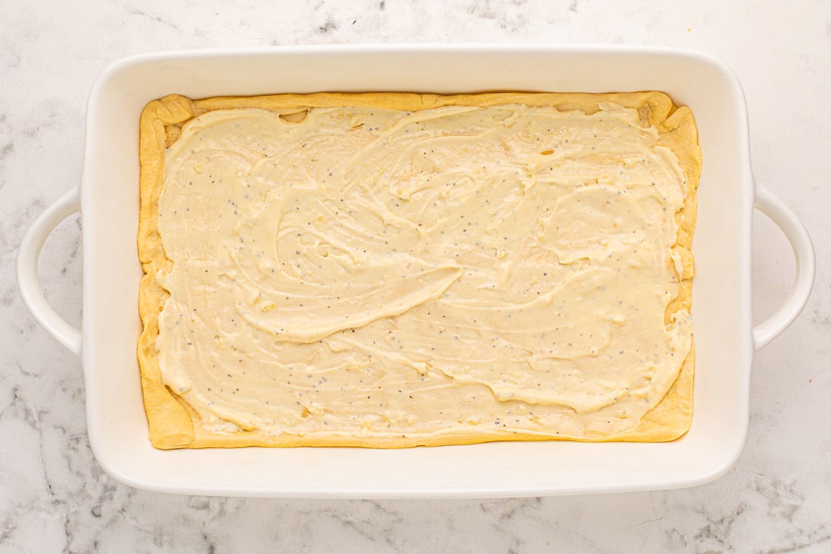 sauce spread on top of crescent dough