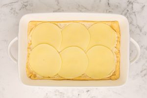 6 slices of provolone cheese placed on top of crescent roll