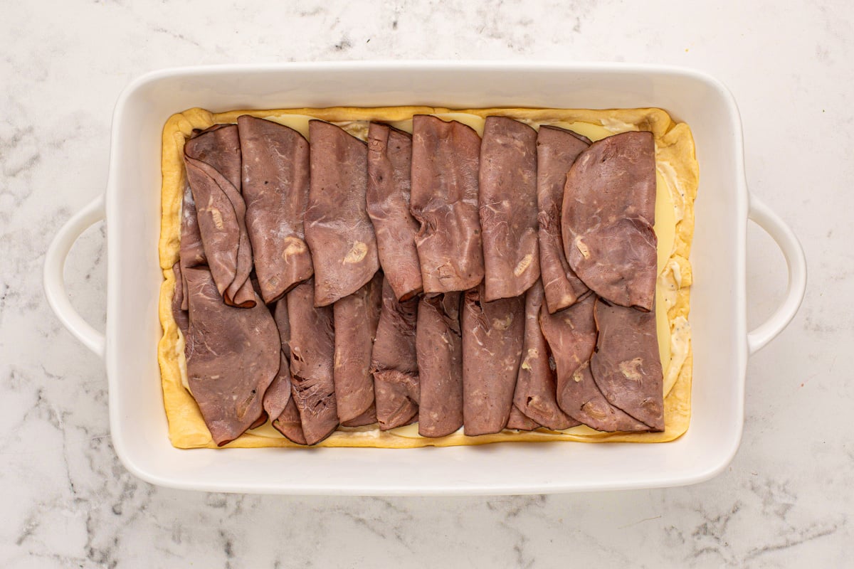 deli roast beef laid on top of cheese