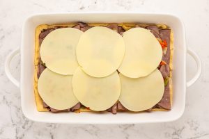 6 slices of cheese onto the top of bell peppers