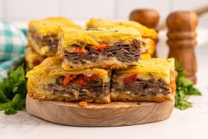 Philly Cheesesteak Squares stacked on a cutting board