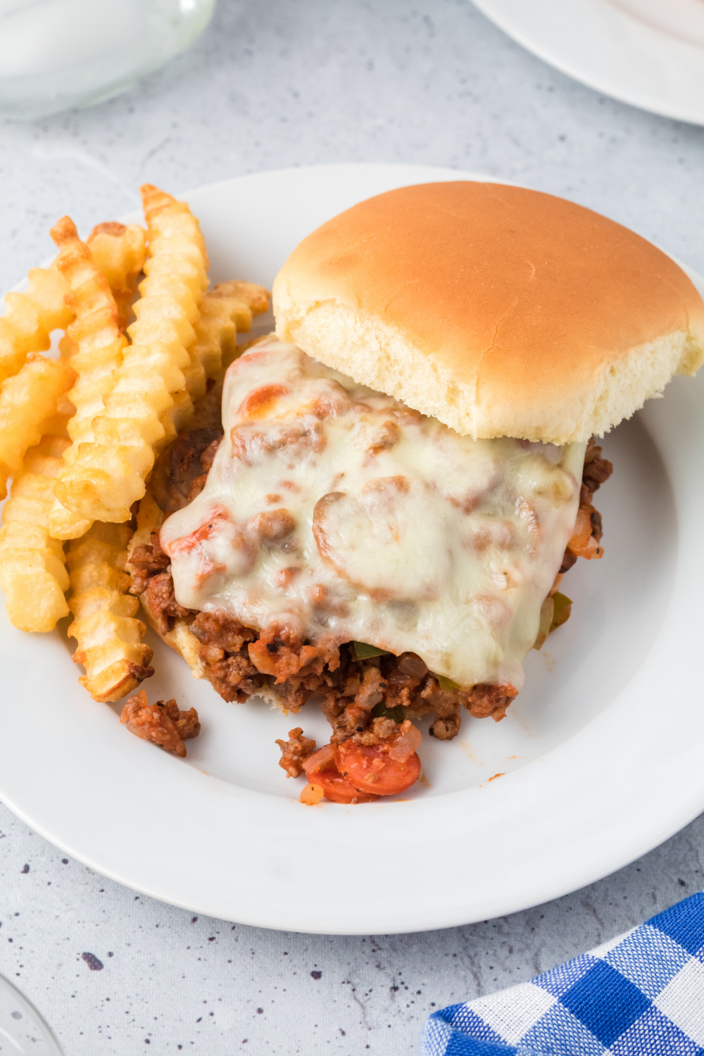 Pizza Sloppy Joe on a plate with french fries