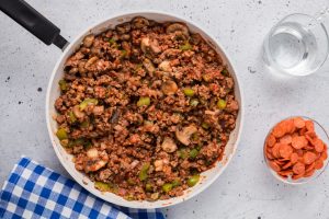 tomato sauce and beef mixture added to pan with veggies