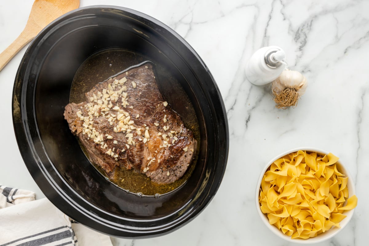 Add seasonings and stock to slow cooker