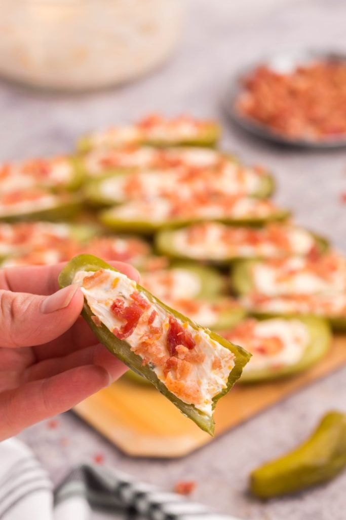 hand holding a stuffed dill pickles