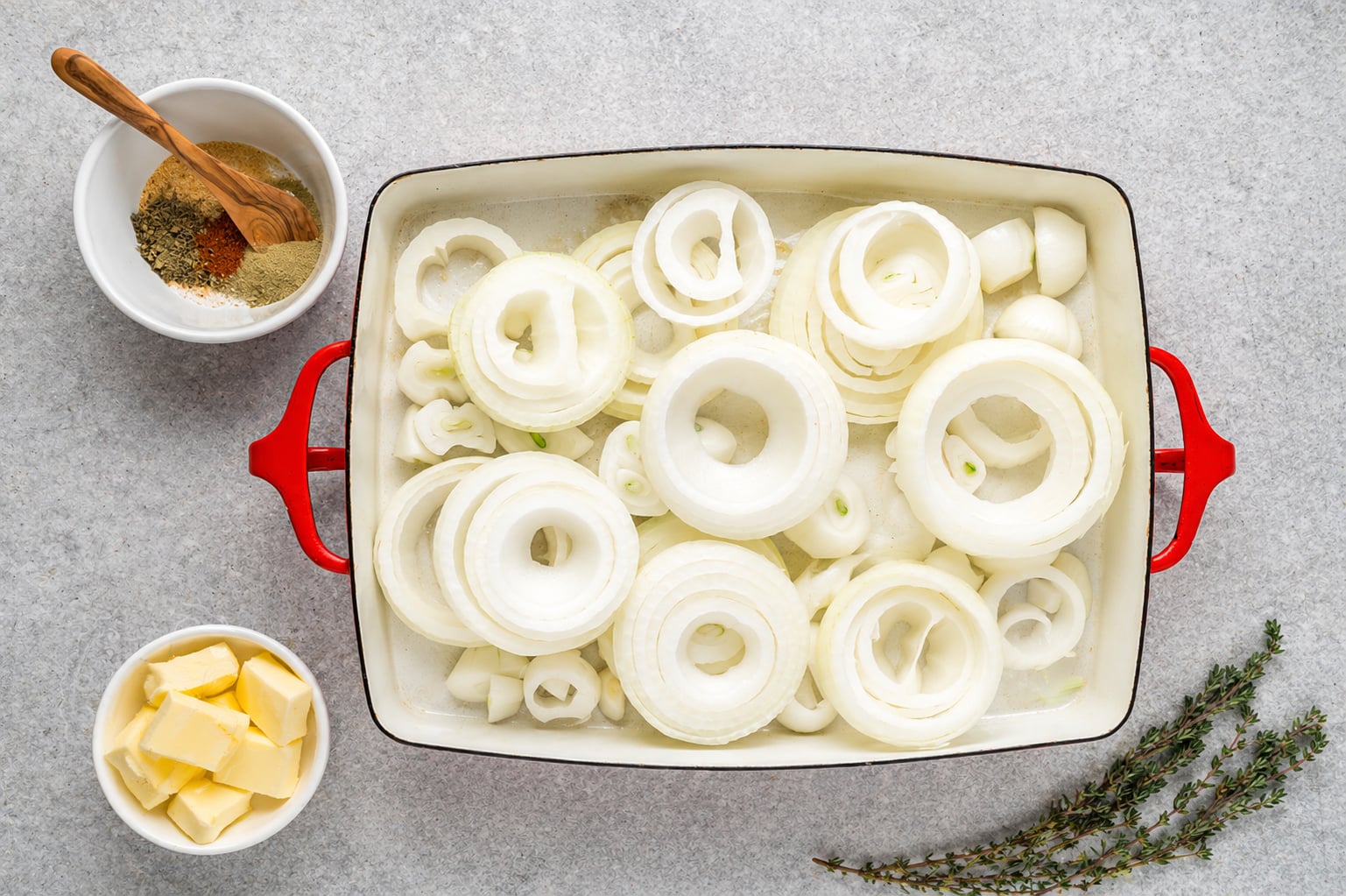sliced onions in a baking dish