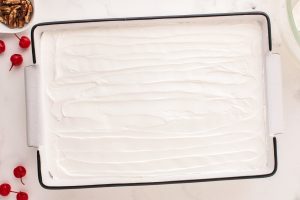 whipped topping spread over pineapples