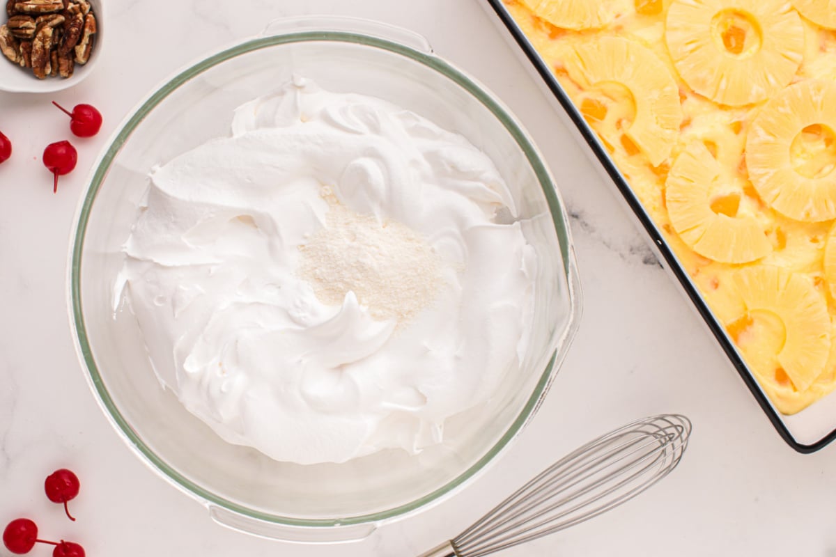 thawed whipped topping with the reserved pudding mix in a bowl