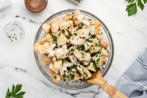 anch seasoning, parsley, salt, and pepper added to bowl with bread