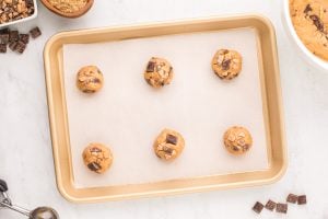 cookie dough balls on a baking sheet