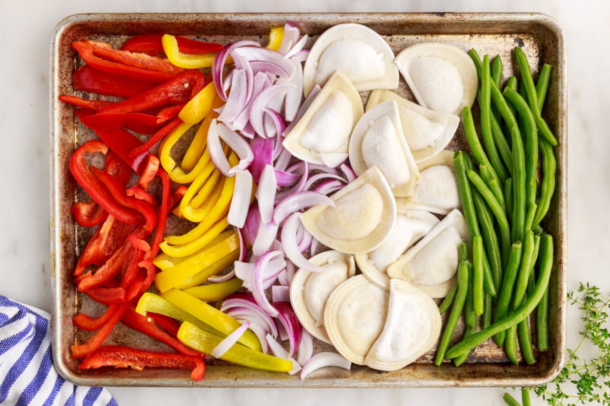 frozen pierogi, and veggies on a sheet pan