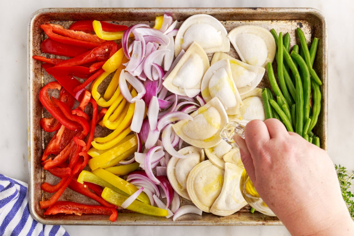 drizzling olive oil over baking sheet