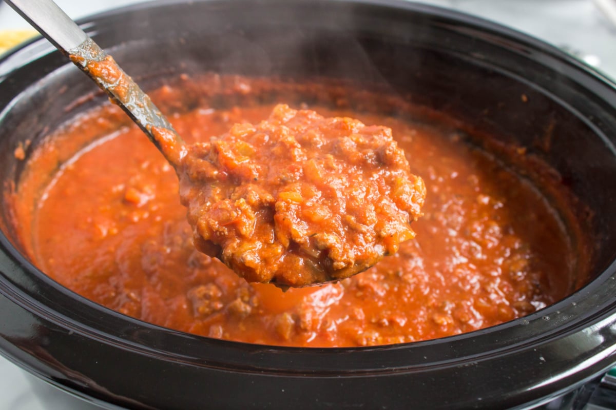 Slow Cooker Bolognese Sauce in a crockpot with a ladle
