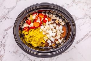 seasoning packet, onion, garlic, beef broth, peperoncini peppers, and giardiniera added to slow cooker