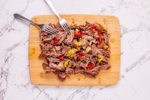shredded beef on a cutting board