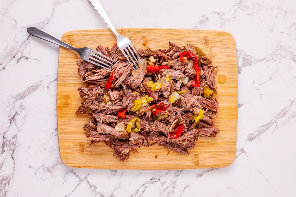 shredded beef on a cutting board