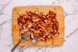 Shredded chicken on a cutting board