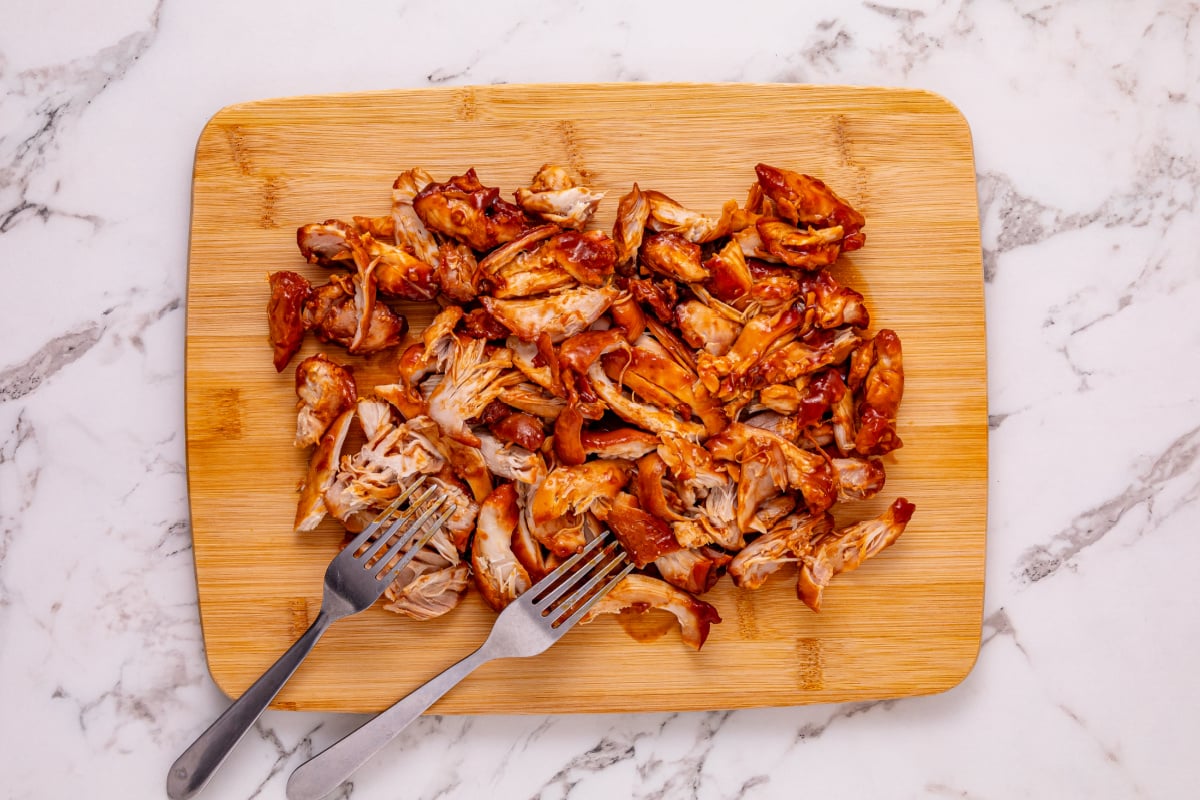 Shredded chicken on a cutting board