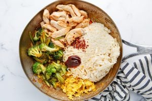 chicken, noodles, vegetables, and sauce in a pan