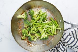 broccoli and green onions in a pan