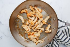 chicken cooking in a pan