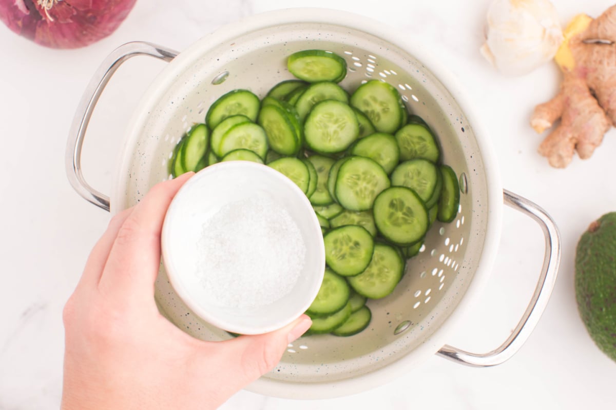 adding salt to cucumbers