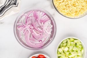 sliced onions in a bowl of water