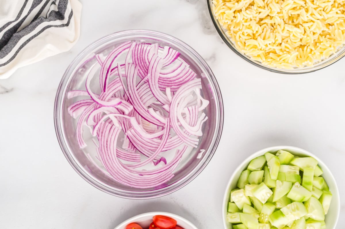 sliced onions in a bowl of water