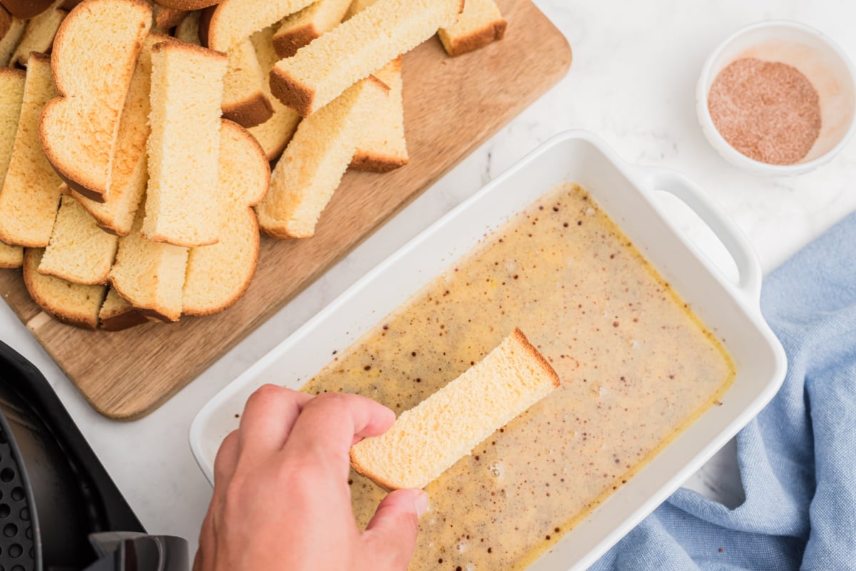 dipping bread pieces in batter