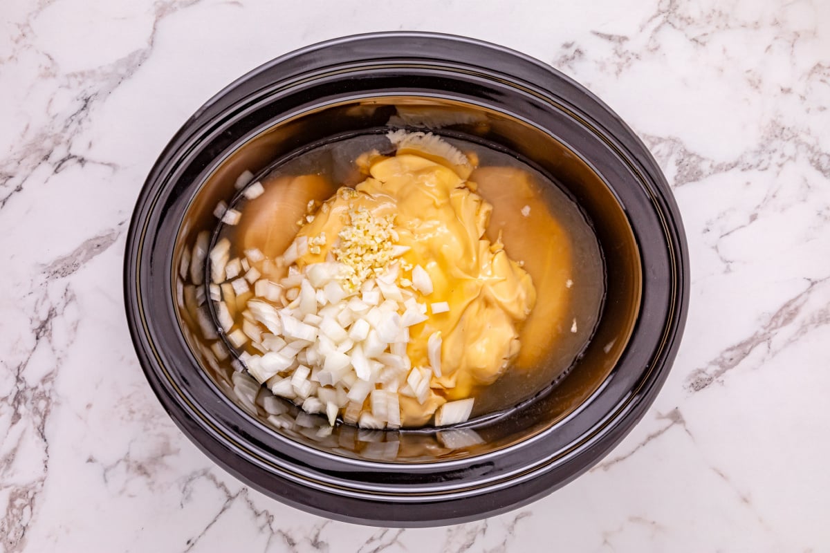 onions, garlic, cream of chicken soup, and chicken broth in a crockpot