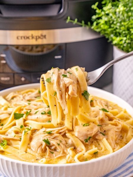 Slow Cooker Chicken and Noodles in a bowl with a fork