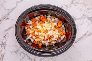 chicken, carrots, onion, garlic, and ginger in a crockpot