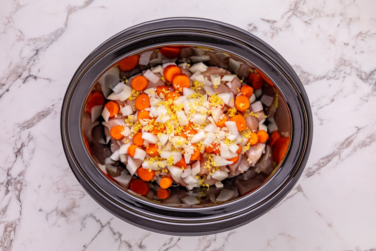 chicken, carrots, onion, garlic, and ginger in a crockpot