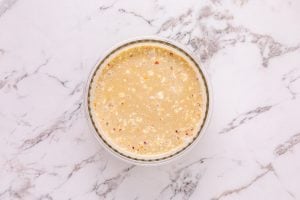 coconut milk, chicken broth, green curry paste, fish sauce, sugar, ground coriander, red pepper flakes, and salt in a bowl