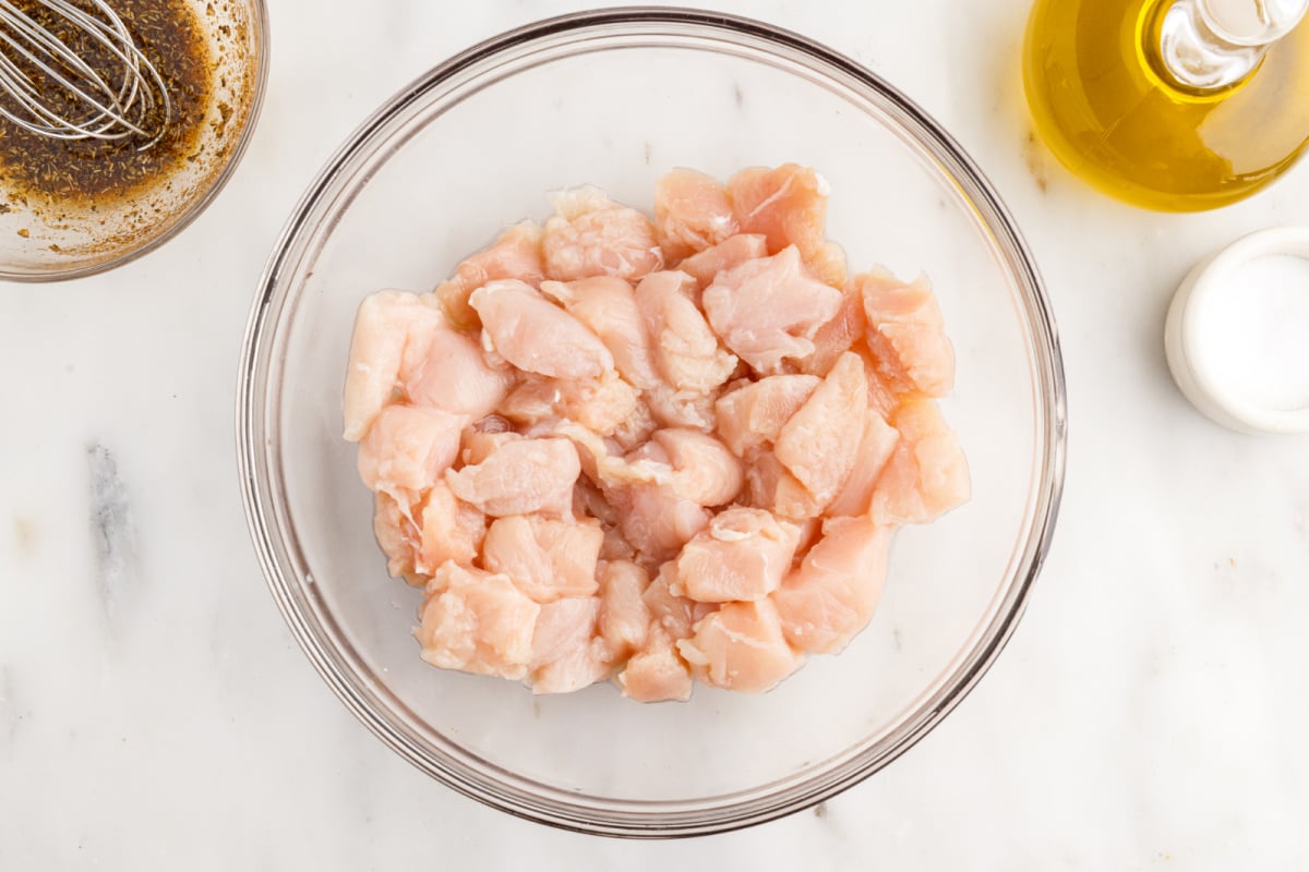cut cut up chicken in a bowl