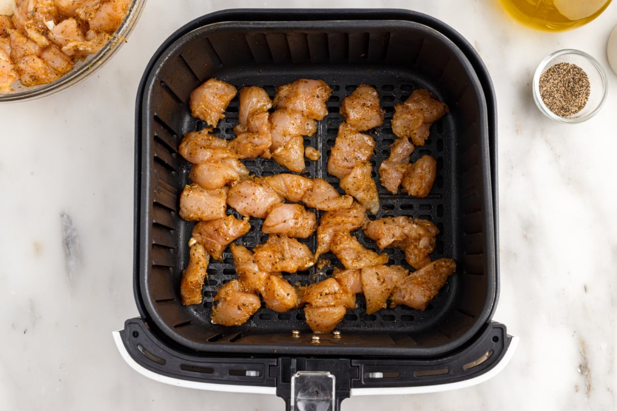chicken placed in air fryer basket
