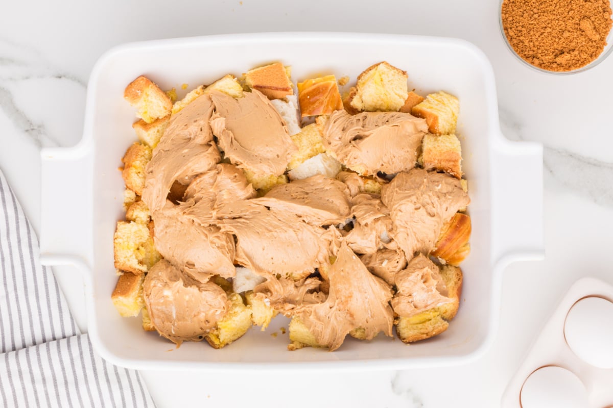 spoonfuls of creamy biscoff mixture placed on top of bread cubes